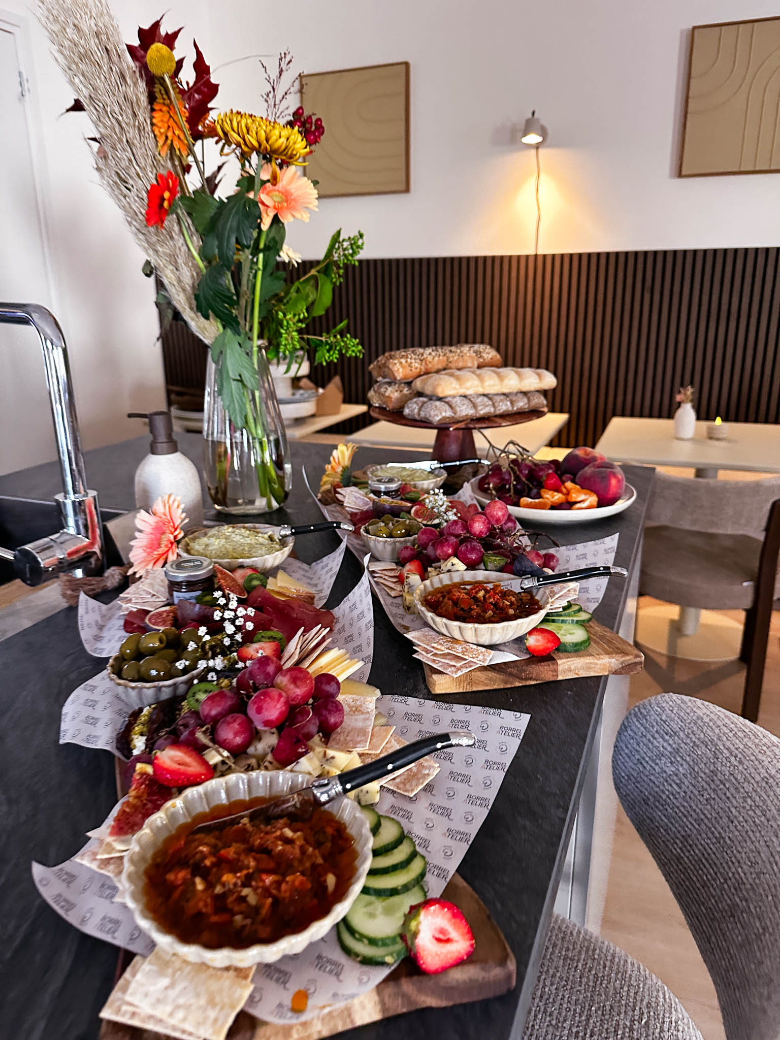 Rijk gevulde tafel met bloemen, schalen en platters op locatie